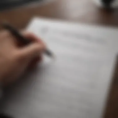 A person reviewing documents with a pen